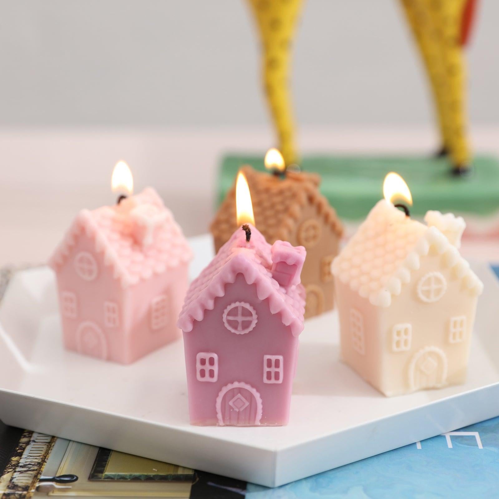 Four single chimney house candles placed in a tray and lit.
