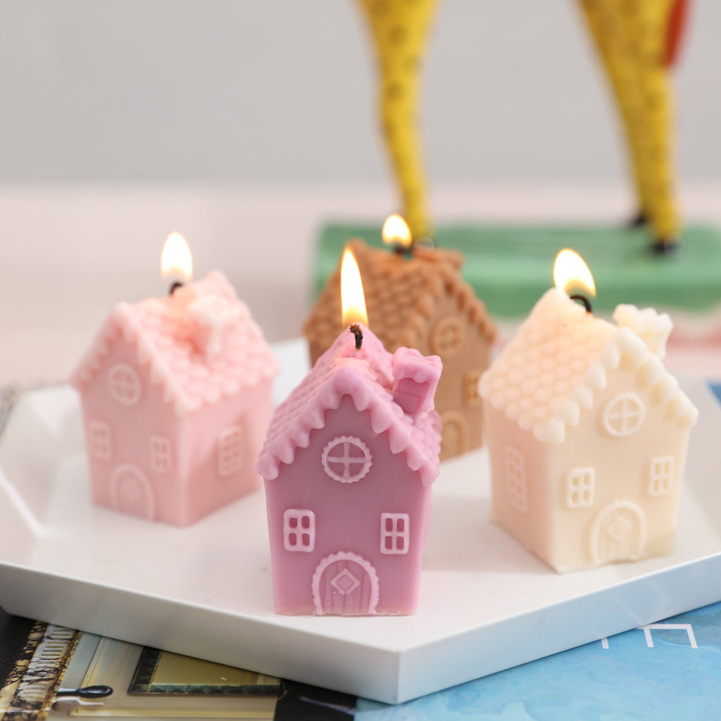 Four single chimney house candles placed in a tray and lit.
