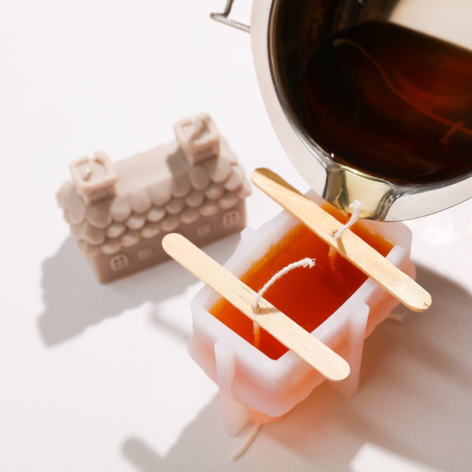 Pour liquid wax into silicone molds to make house candles, demonstrating the product's attention to detail.