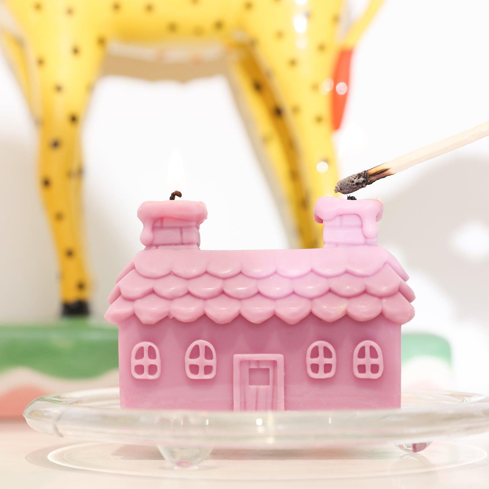 Twin Chimney House Candles on a glass tray on the tabletop.
