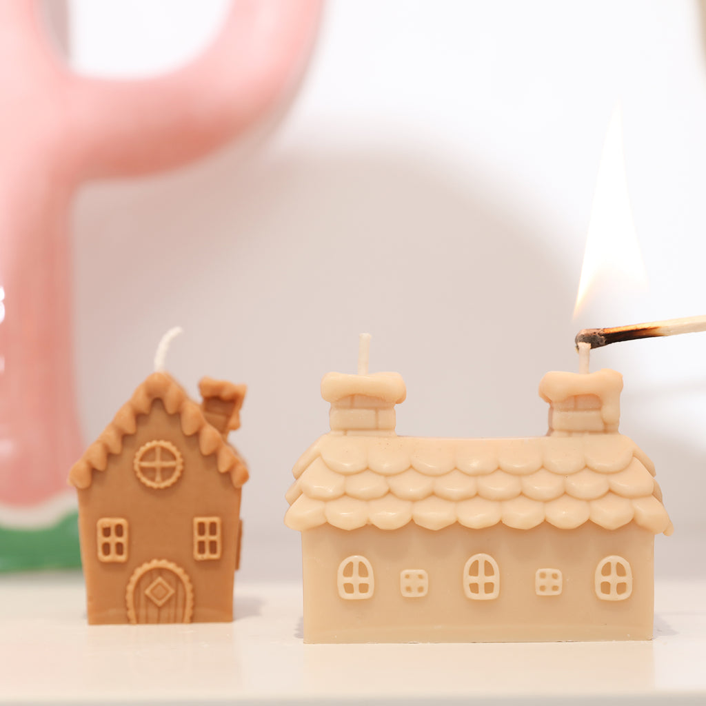 Single and double chimney houses with candles placed on the table.
