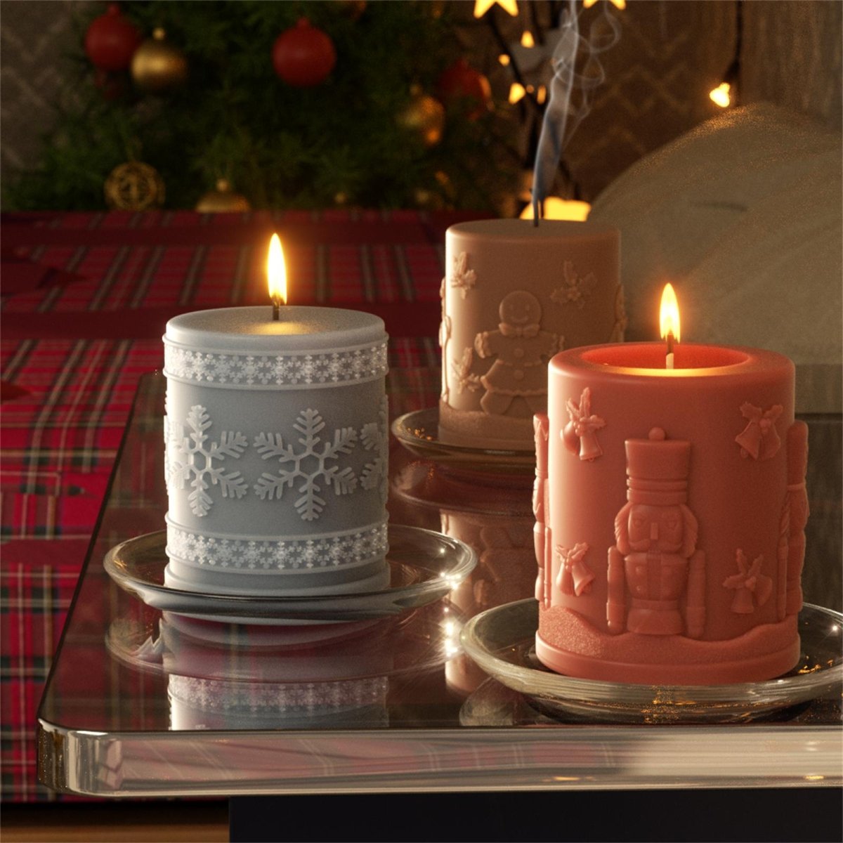 Three embossed Christmas pillar candles—Snowflake, Gingerbread, Nutcracker—lit and displayed on clear trays in a festive holiday setting -Boowan Nicole