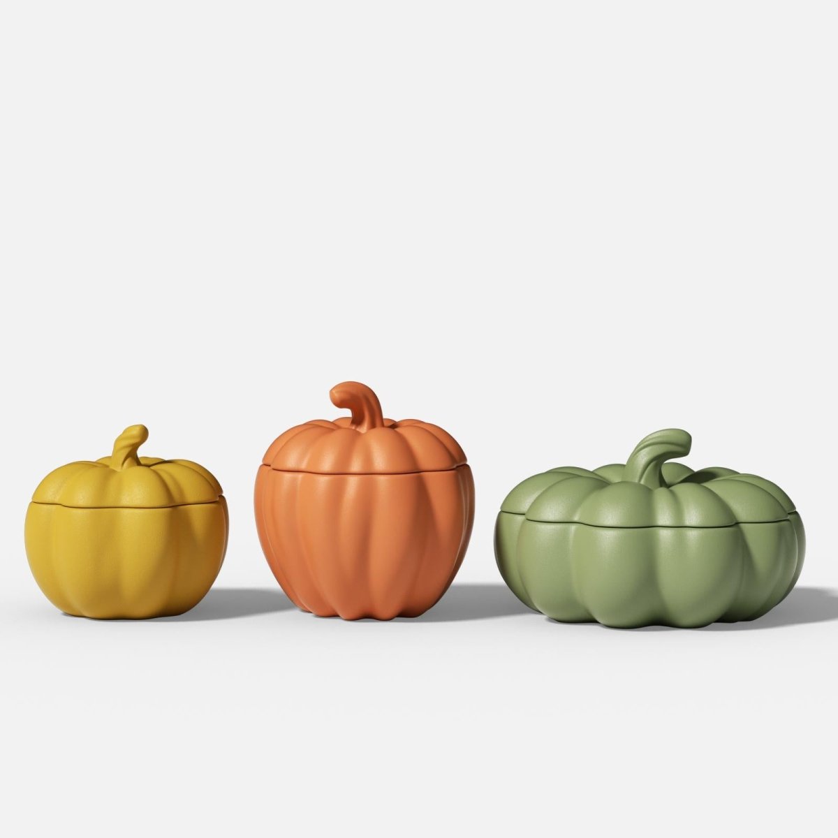 Three pumpkin-shaped candle jars in yellow, orange, and green - Boowan Nicole