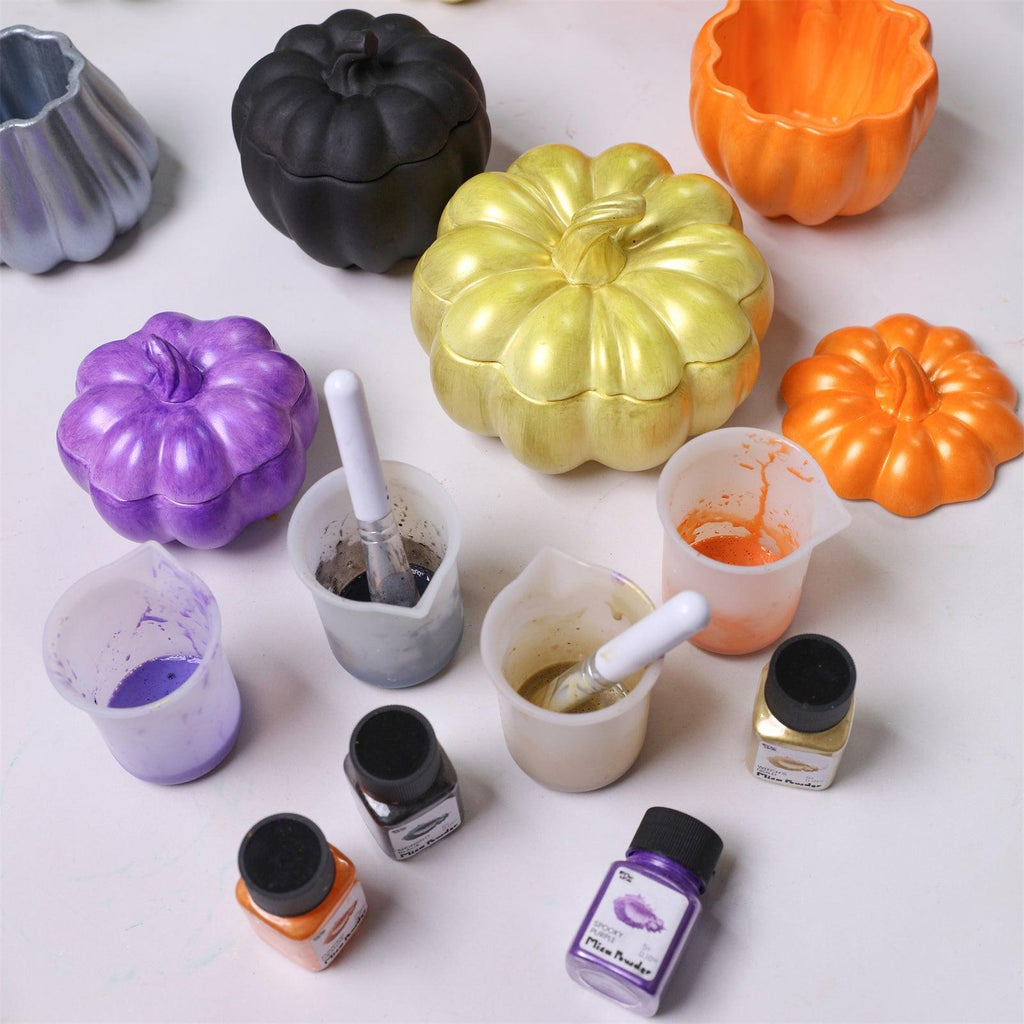 Hand-painted pumpkin candle jars in metallic purple, gold, black, and orange – with mica powder, brushes, and mixing cups for DIY decoration - Boowan Nicole