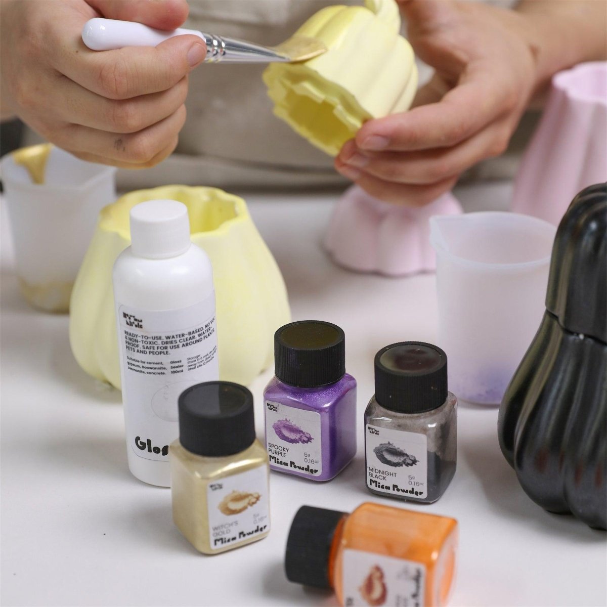 Hand painting a pumpkin candle jar with mica powder and glossy varnish for DIY decoration - Boowan Nicole