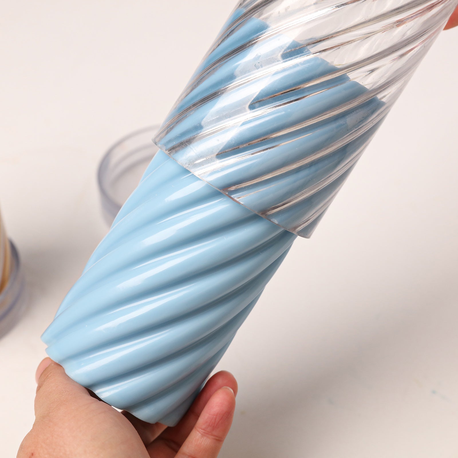 Demolding light blue twisted spiral pillar candle from acrylic mold - Boowan Nicole