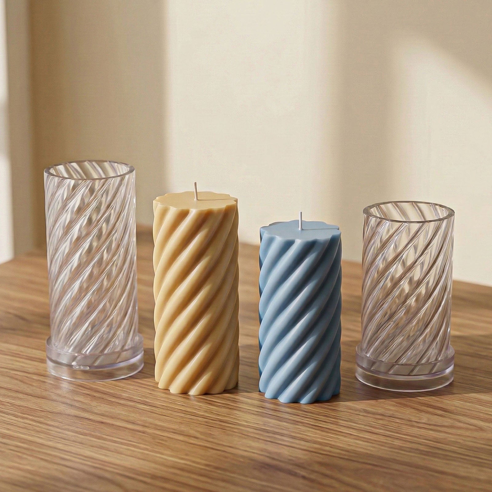 Two sizes of twisted spiral acrylic candle molds with finished amber and blue candles - Boowan Nicole