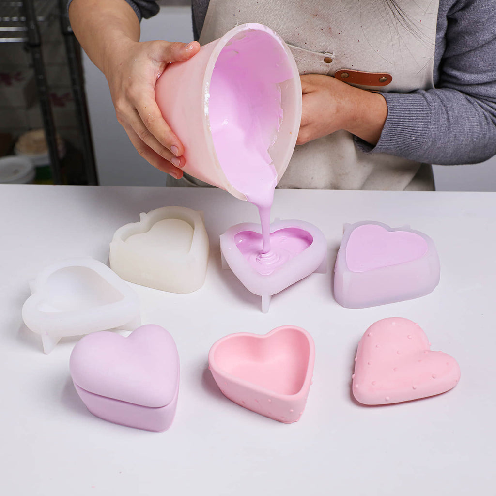 Pouring the prepared purple concrete mixture into a heart-shaped candle jar silicone mold - Boowan Nicole