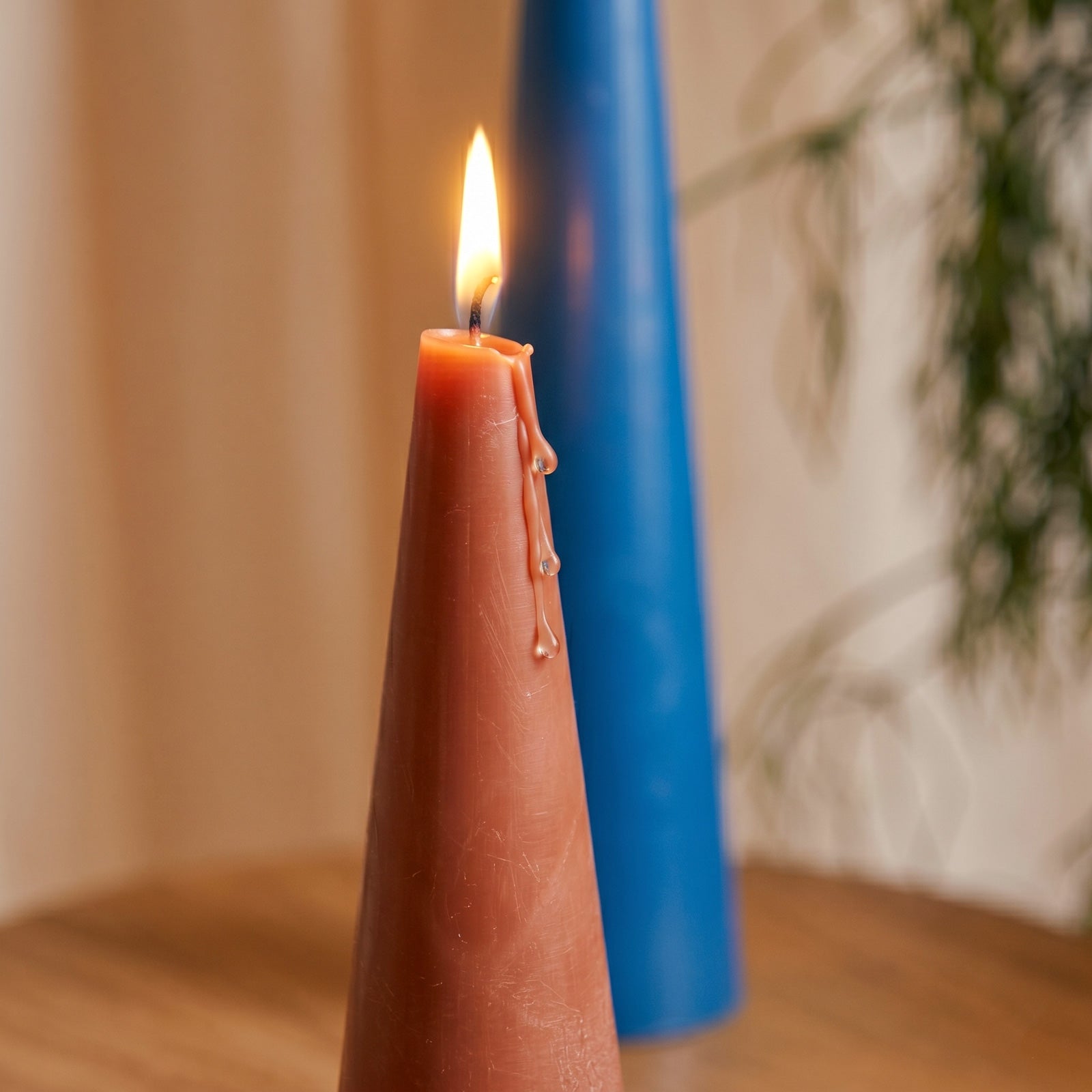 Close-up of Lit Red Cone Candle with Melting Wax - Boowan Nicole