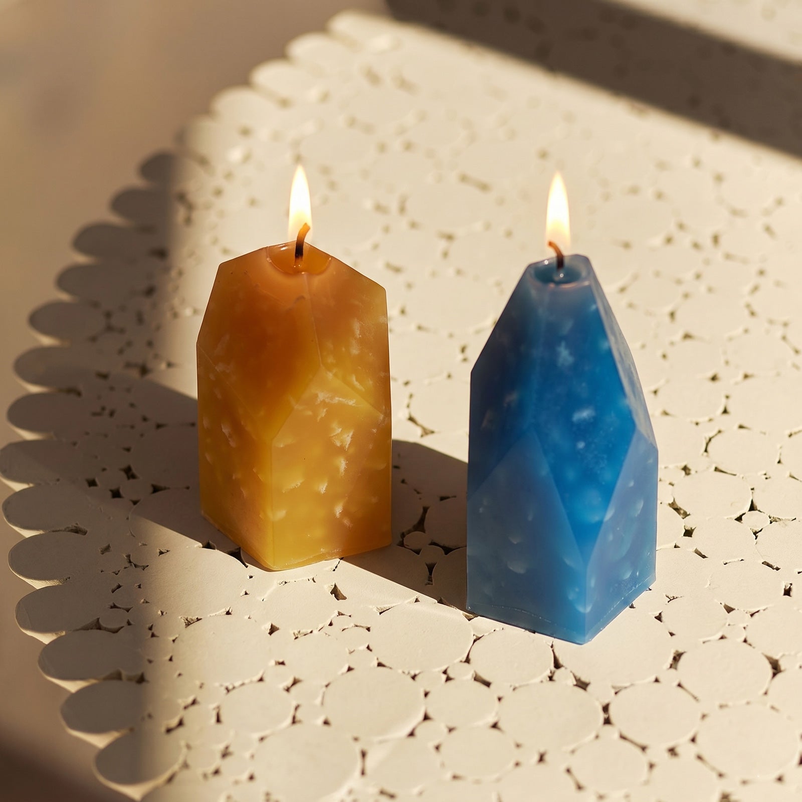 Lit Yellow & Blue Crystal Candles on Lace Surface - Boowan Nicole