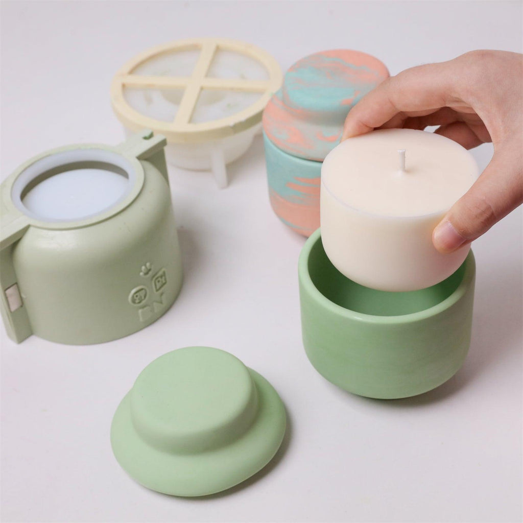 Placing refill candle insert into finished green concrete candle jar - Boowan Nicole