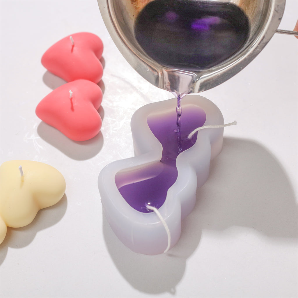 Pouring purple wax into silicone molds-Boowan Nicole