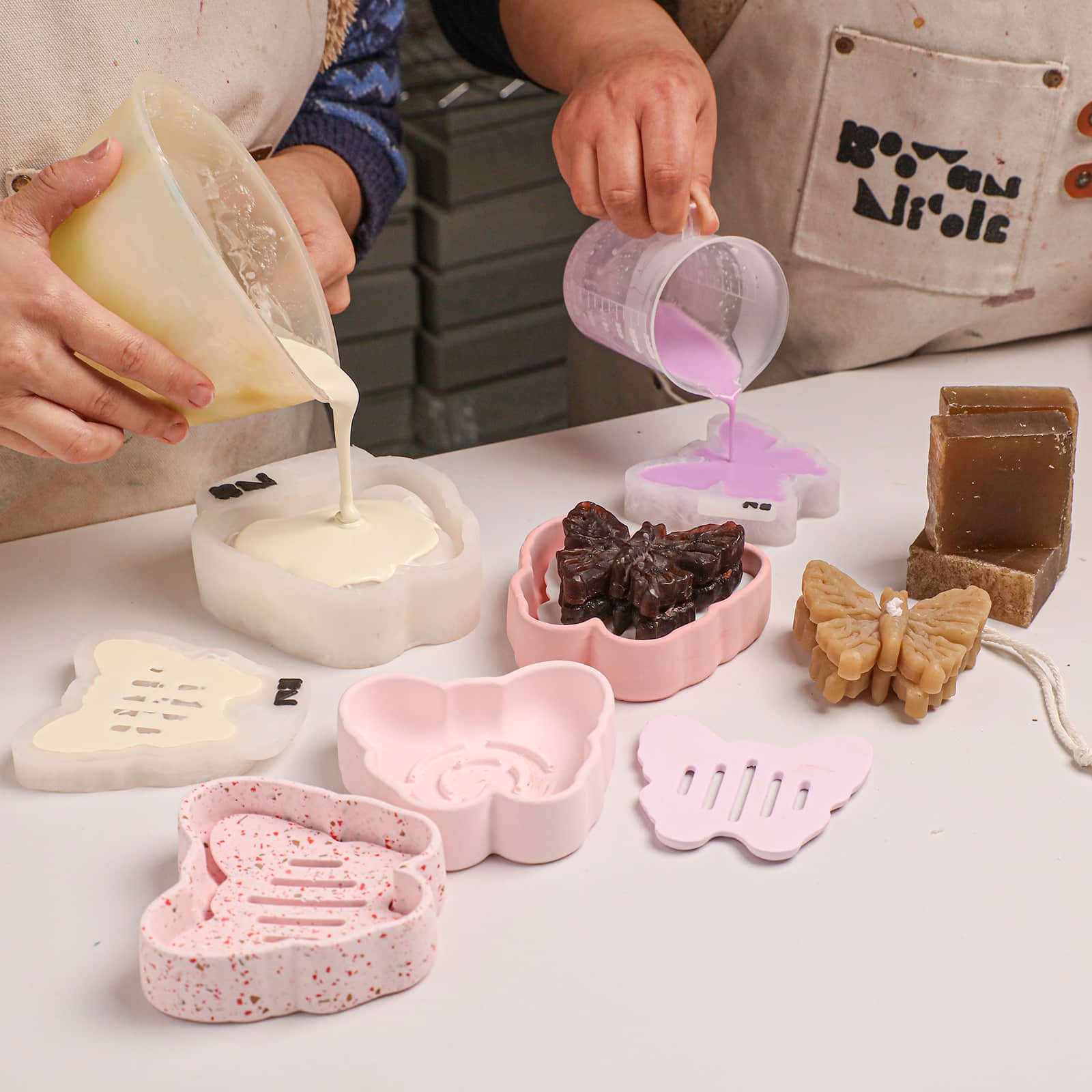 Crafting process: pouring casting material into butterfly soap and dish silicone molds - Boowan Nicole