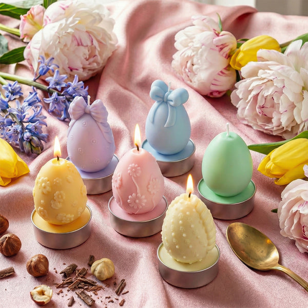 Lit pastel Easter egg candles arranged on a pink fabric with peonies and tulips for spring decor -Boowan Nicole