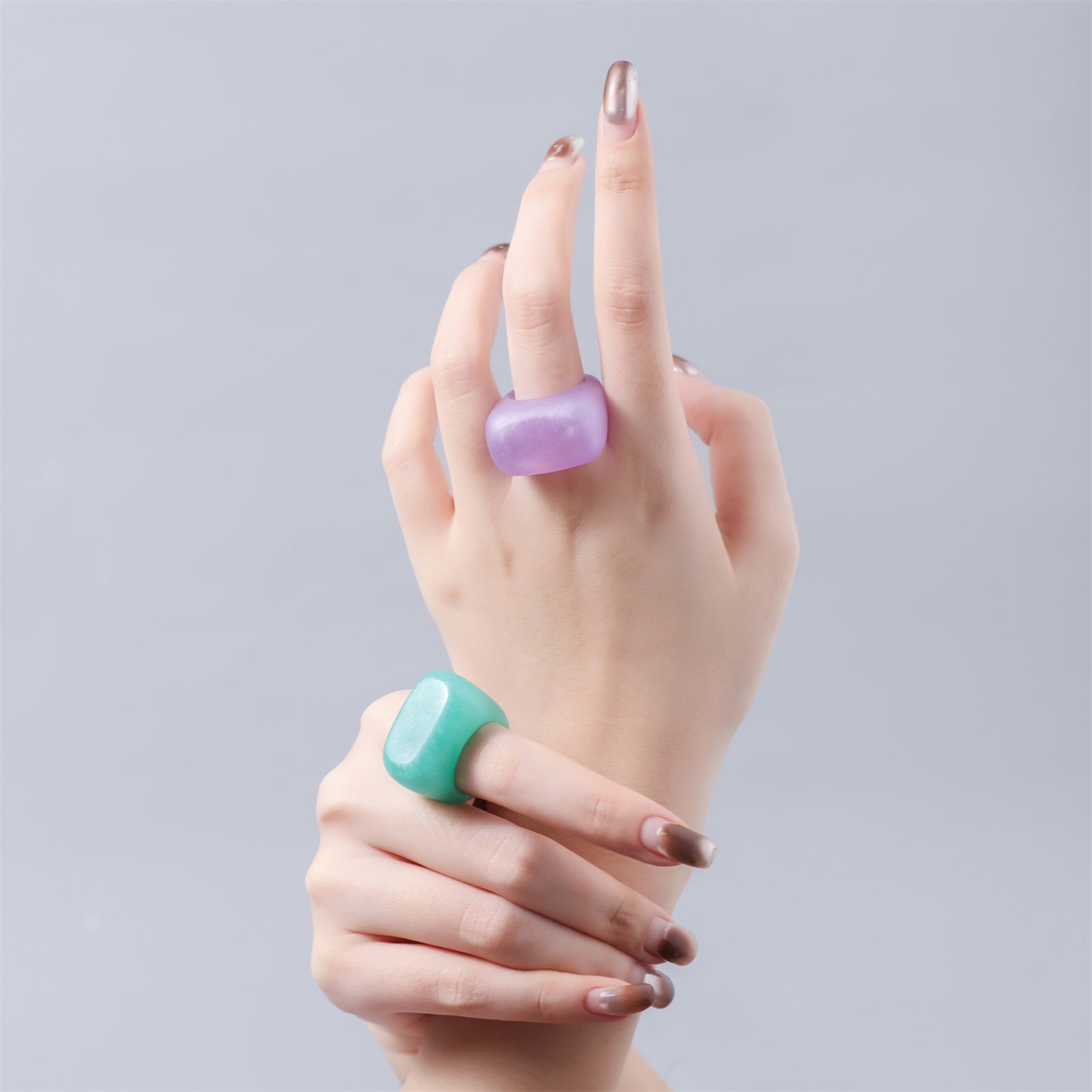 Handcrafted ring close-up on elegant woman’s hand, glimmering in natural light—exquisite craftsmanship, unique design-Boowan Nicole