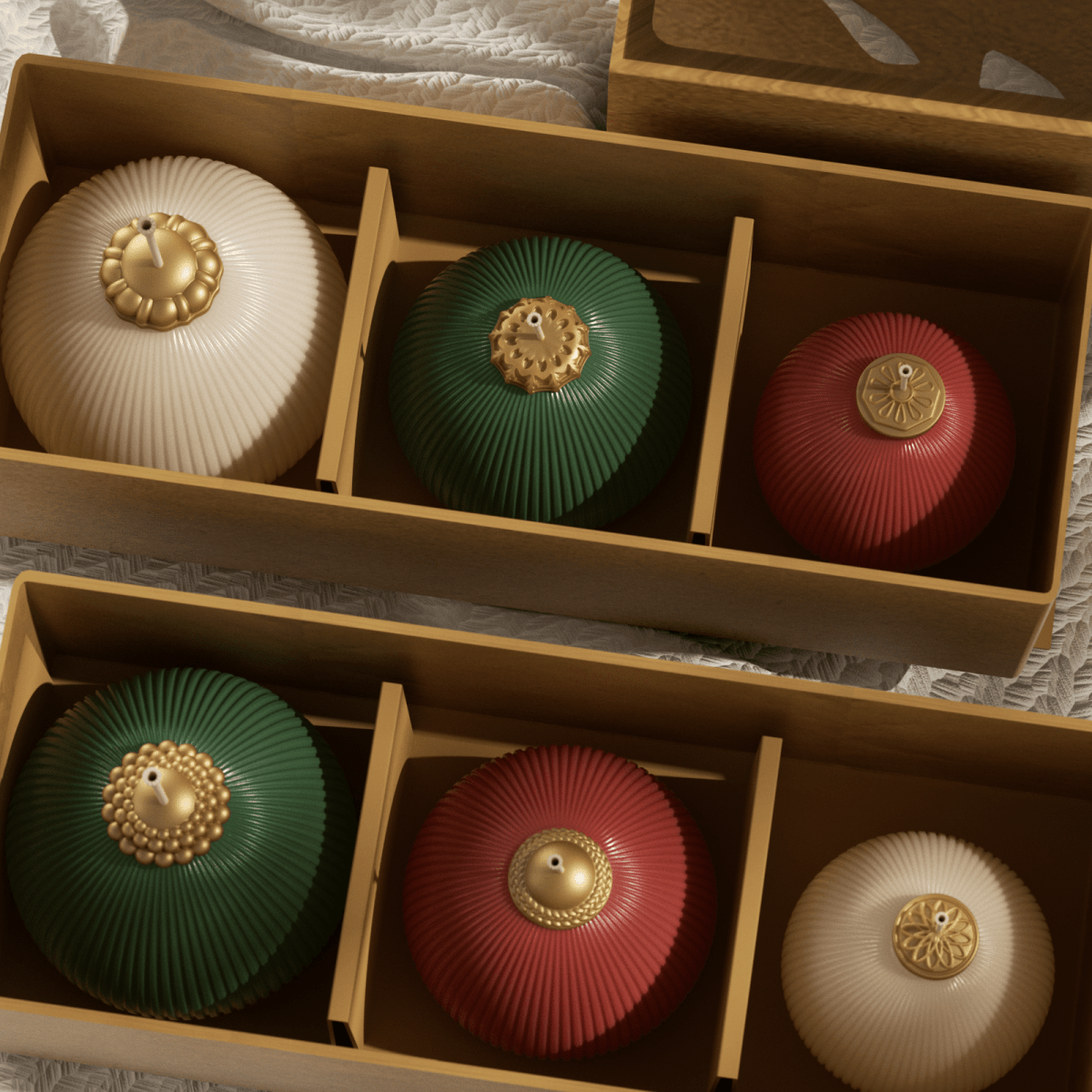 Wooden gift boxes holding ivory, green, and red ribbed bauble candles with gold caps, neatly divided into compartments—Christmas candle set - Boowan Nicole