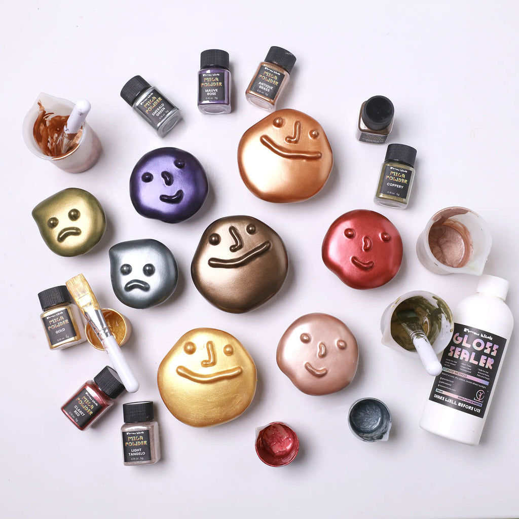 Array of metallic pebble-face wall hooks—happy, calm & pouty—in gold, copper, bronze, green and purple, with mica powders, brushes and gloss sealer - Boowan Nicole