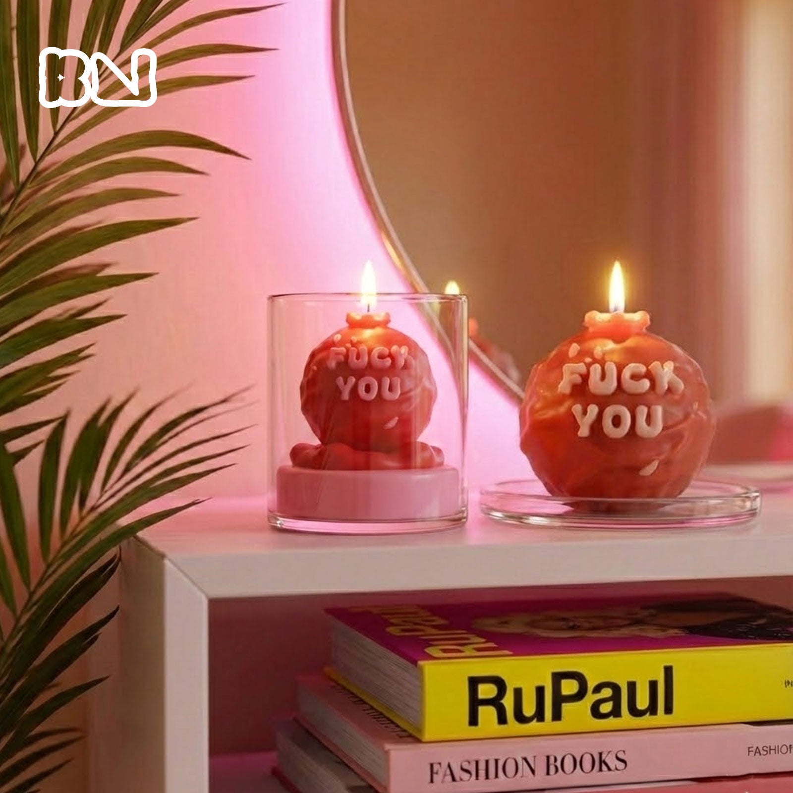 Lit red "F*CK YOU" slogan candles in a pink aesthetic room setting - Boowan Nicole