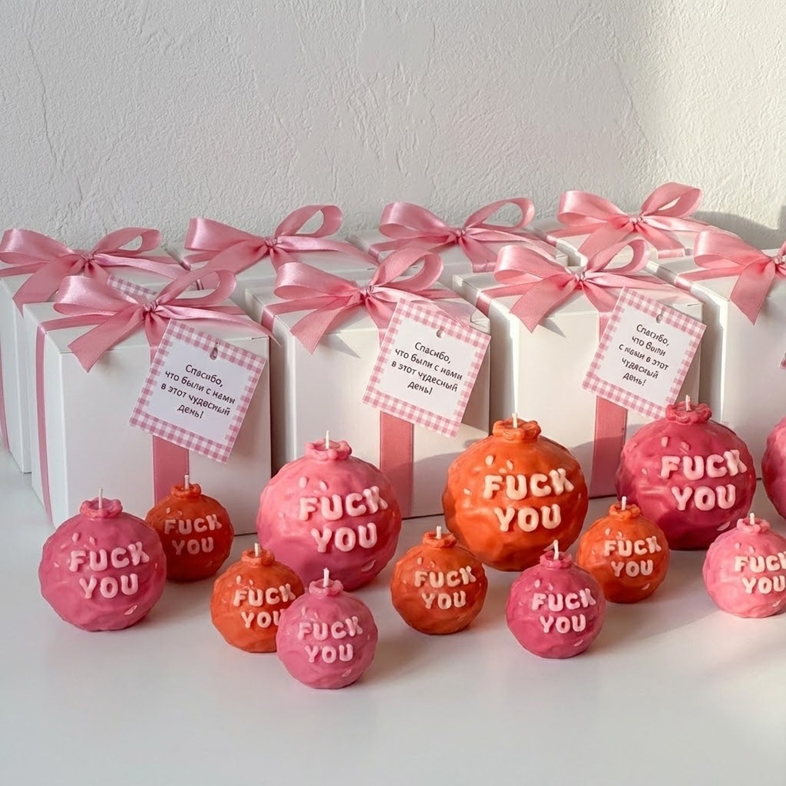 Assorted pink and red "F*CK YOU" slogan ball candles with elegant gift box packaging and pink ribbons - Boowan Nicole
