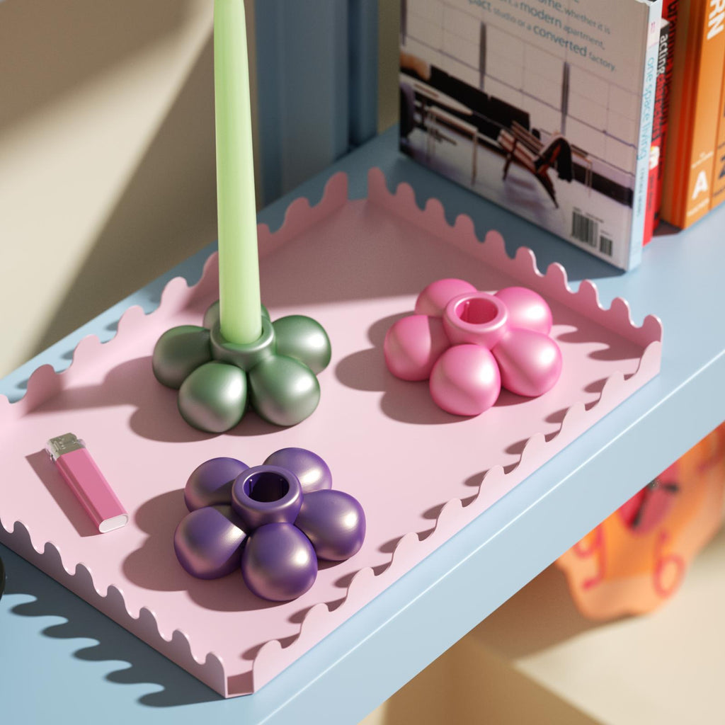 Colorful flower-shaped candle holders on a pink tray, adding a playful touch to modern home decor-Boowan Nicole