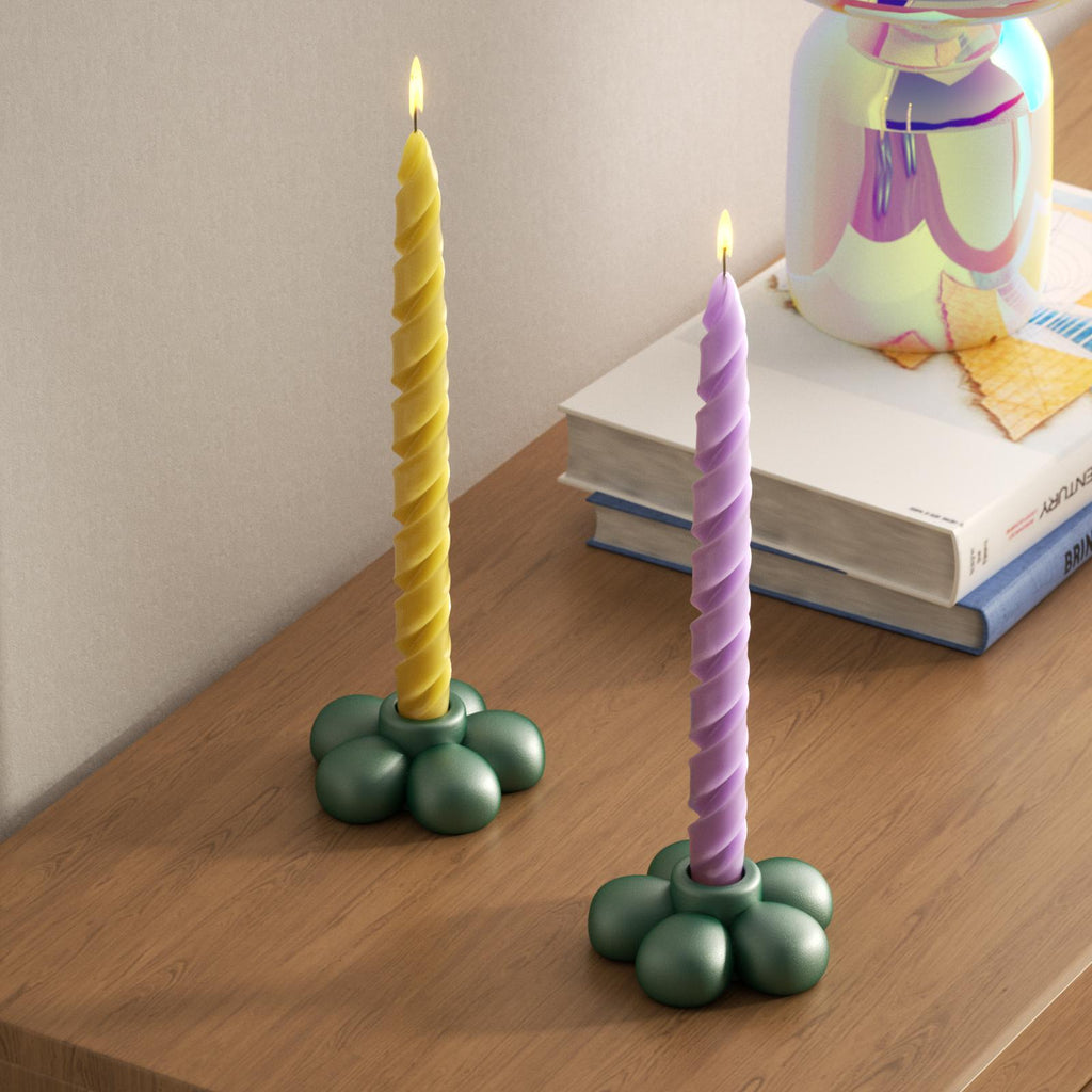 Green flower-shaped candle holder paired with purple and yellow twisted taper candles, adding a playful and vibrant touch to any room-Boowan Nicole