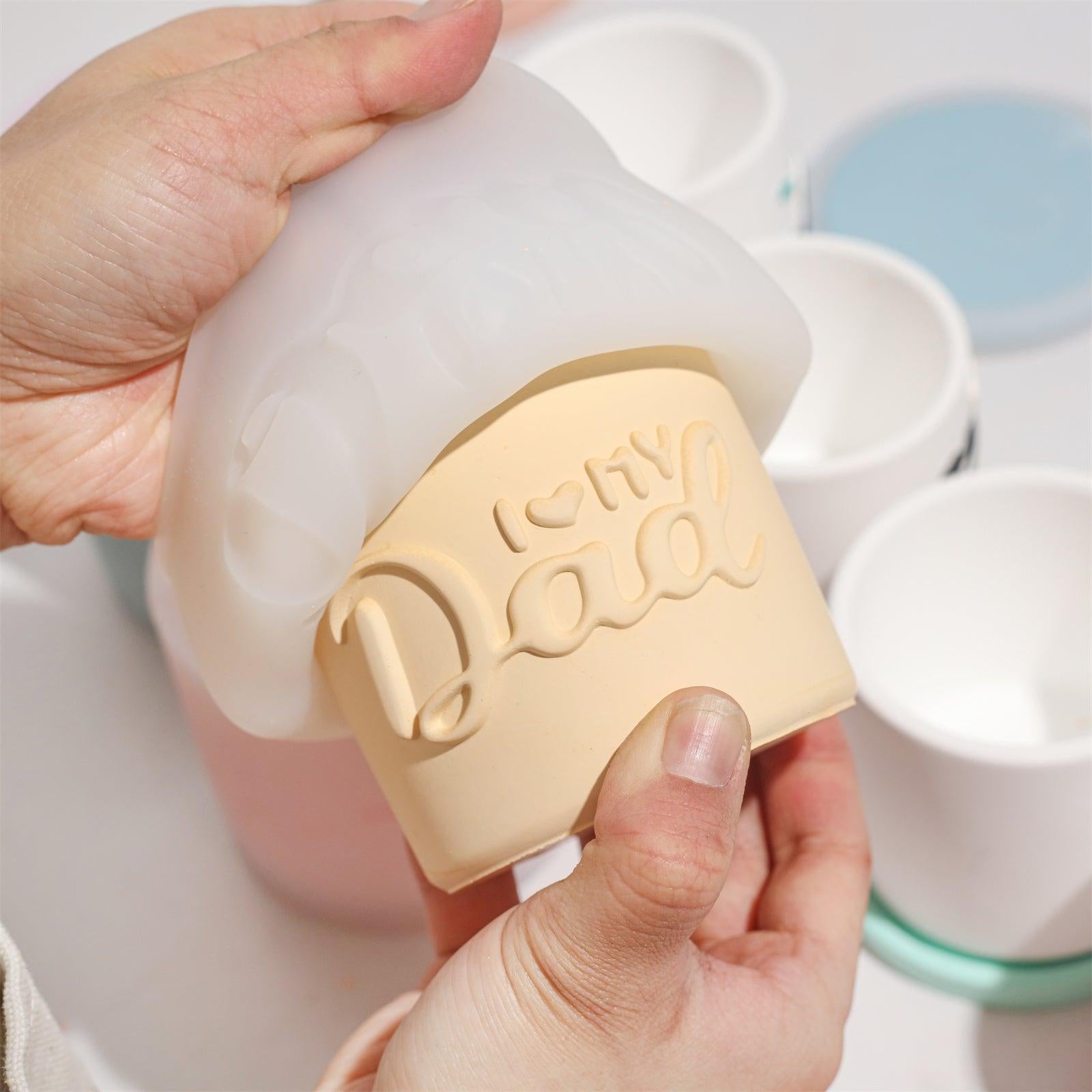 Demolded from a silicone mold, the yellow flowerpot features an embossed 'Dad' design-Boowan Nicole