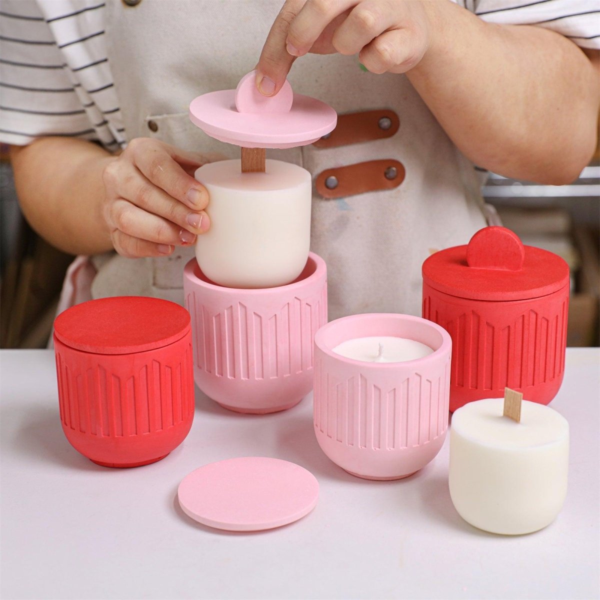 Placing a refill candle insert into a finished pink geometric candle jar - Boowan Nicole