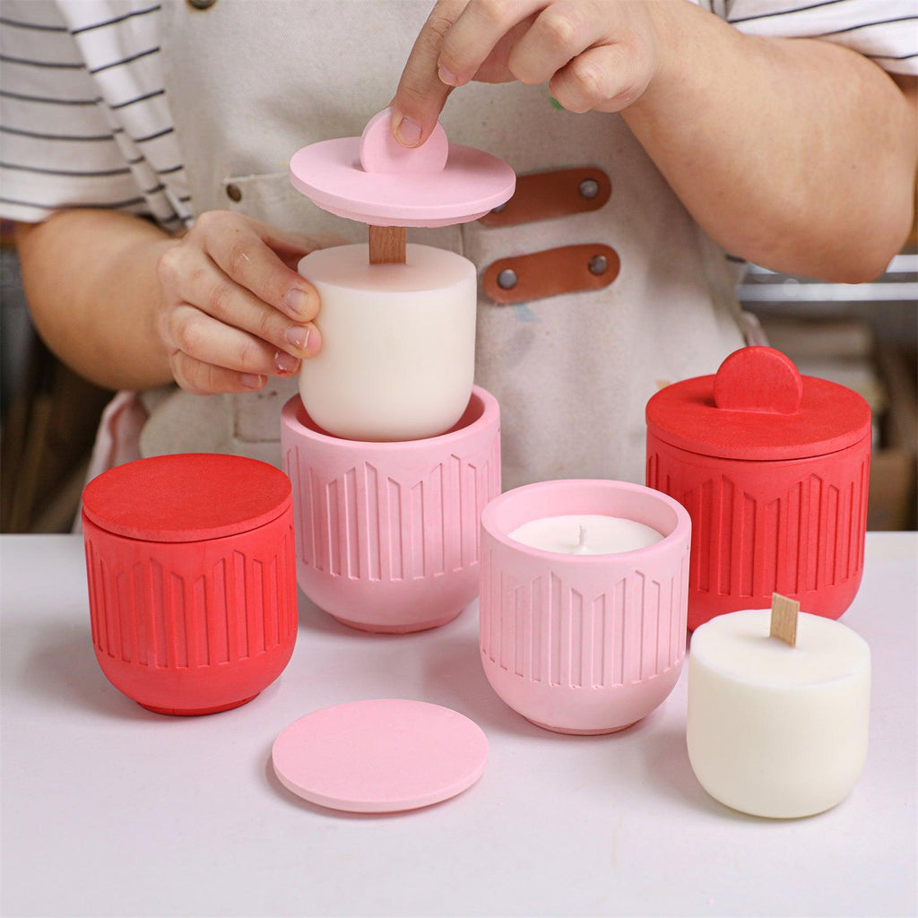Placing a refill candle insert into a finished pink geometric candle jar - Boowan Nicole
