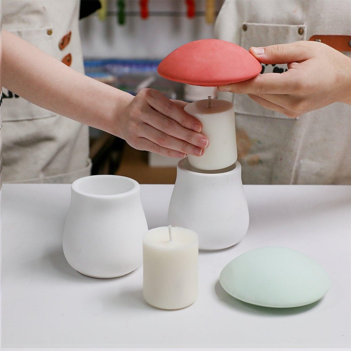 Placing a finished refill candle insert into a concrete mushroom-shaped candle jar - Boowan Nicole
