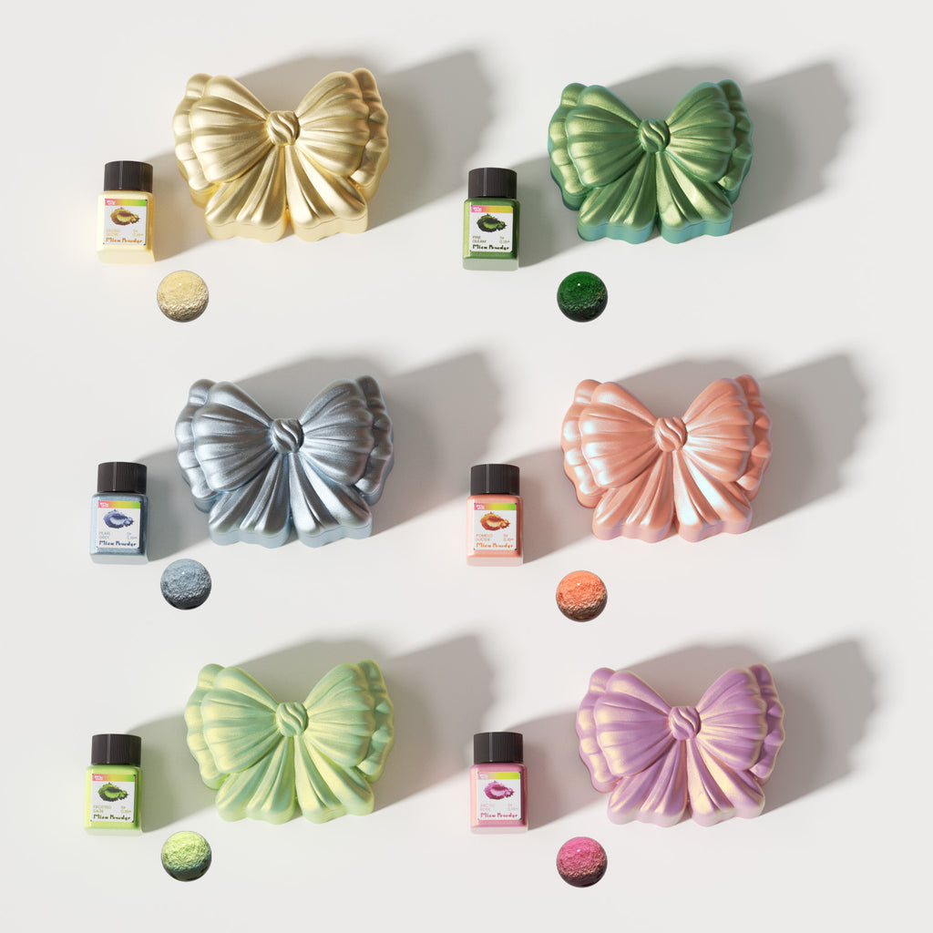 Colorful bow-shaped candle jars in metallic finishes with matching mica powder bottles, displayed in gold, green, silver, peach, yellow, and purple - Boowan Nicole