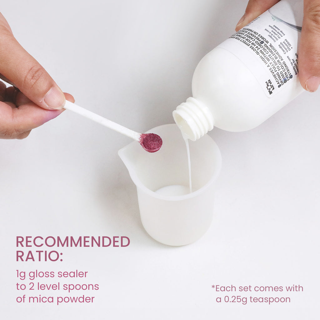 Hand pouring gloss sealer into silicone cup while adding mica powder with a small spoon, showing recommended mixing ratio for DIY crafts - Boowan Nicole
