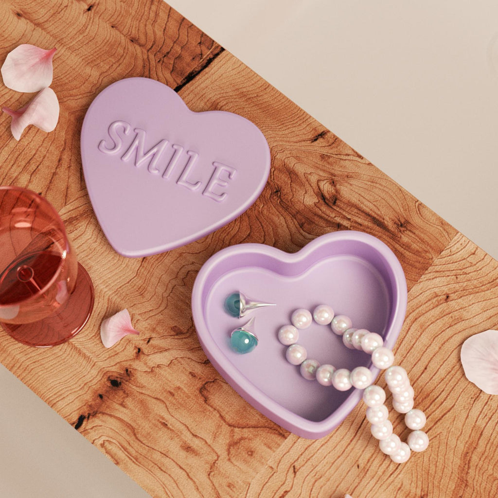 Heart-shaped storage box with "SMILE" embossed text, used for storing necklaces and rings, adding a charming touch to the decorative scene-Boowan Nicole
