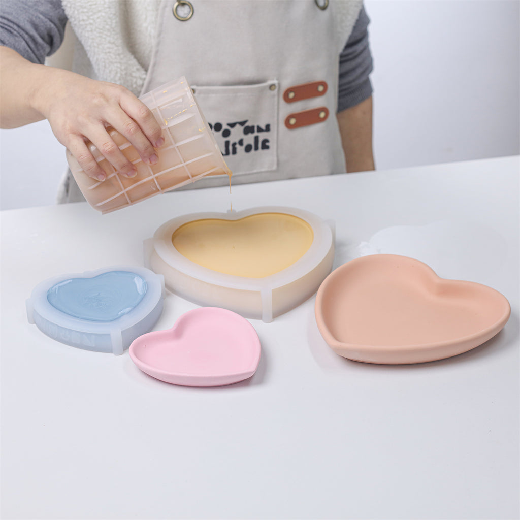 Pouring material into a large heart-shaped silicone mold to craft-Boowan Nicole