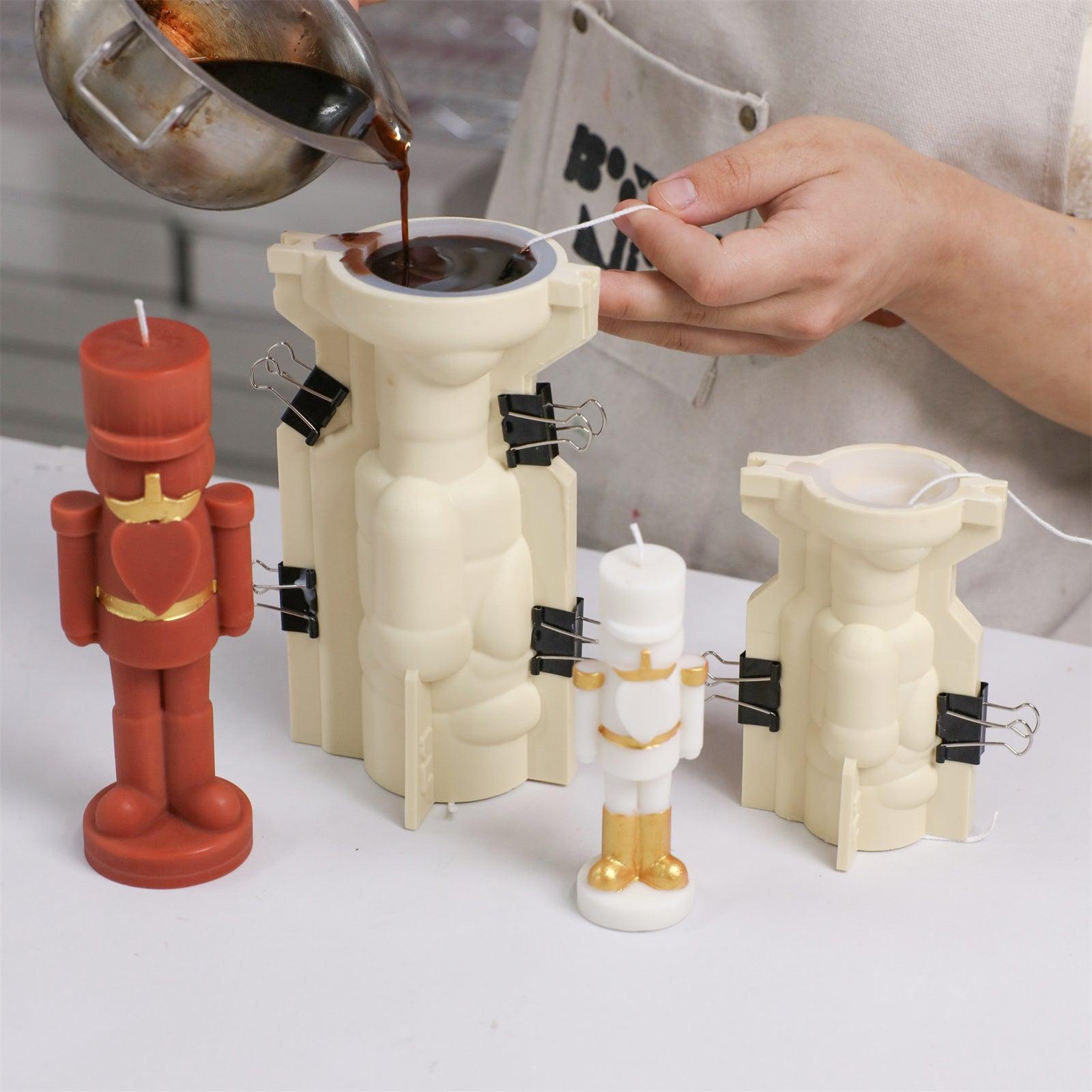 Pouring wax into nutcracker-shaped silicone molds with outer support shells - Boowan Nicole