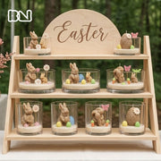 Aesthetic Easter display with bunny and egg-shaped candles in glass containers on a wooden stand - Boowan Nicole