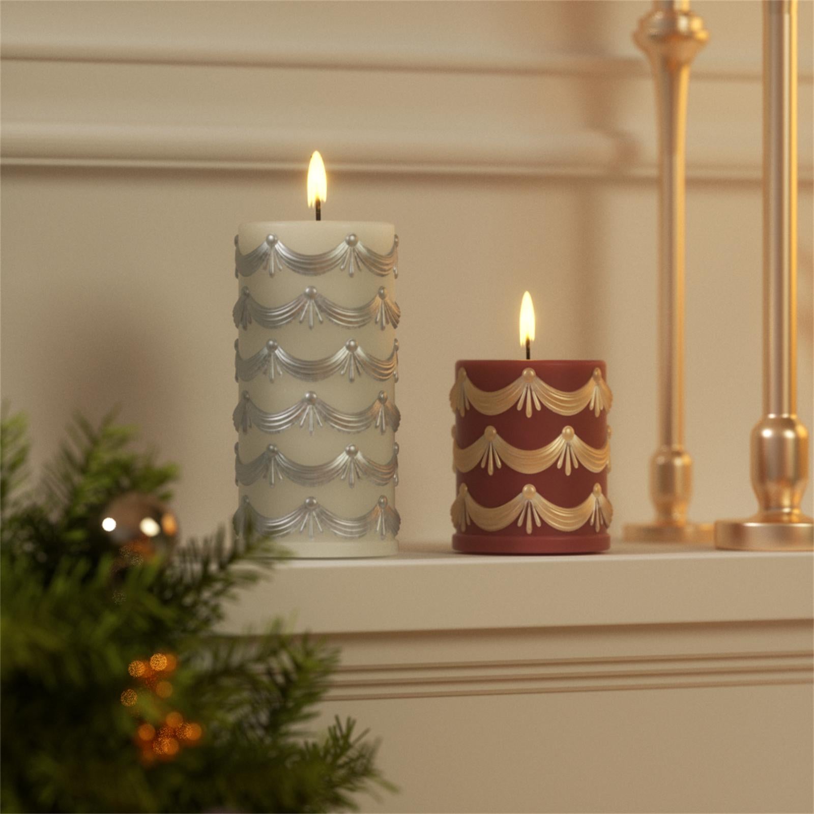 Lit ivory and red pillar candles with metallic swag relief patterns on a holiday mantel decor setup - Boowan Nicole