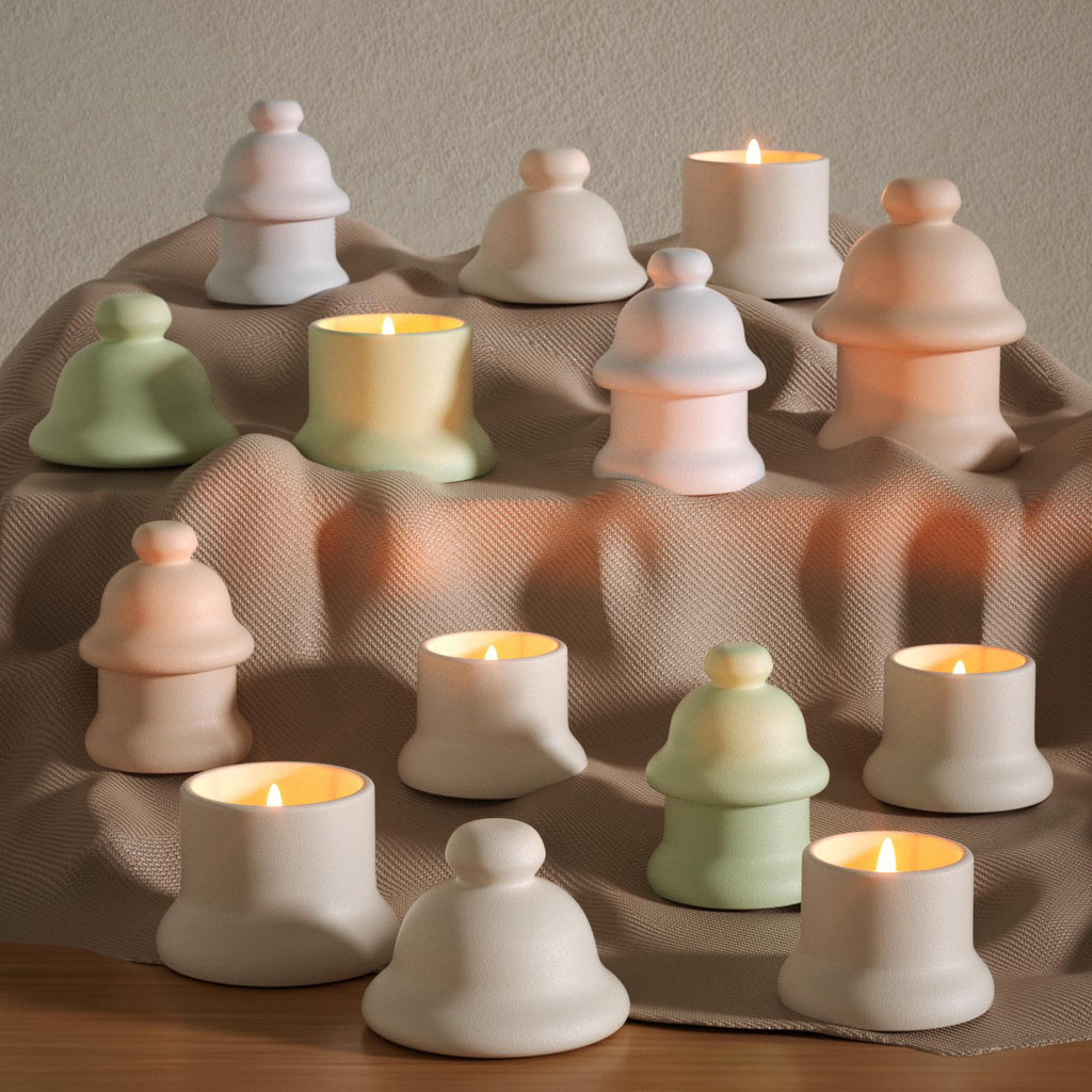 Jingle Bell candles jar in matte pastel tones, arranged on textured fabric – handmade decor for cozy modern interiors - Boowan Nicole

