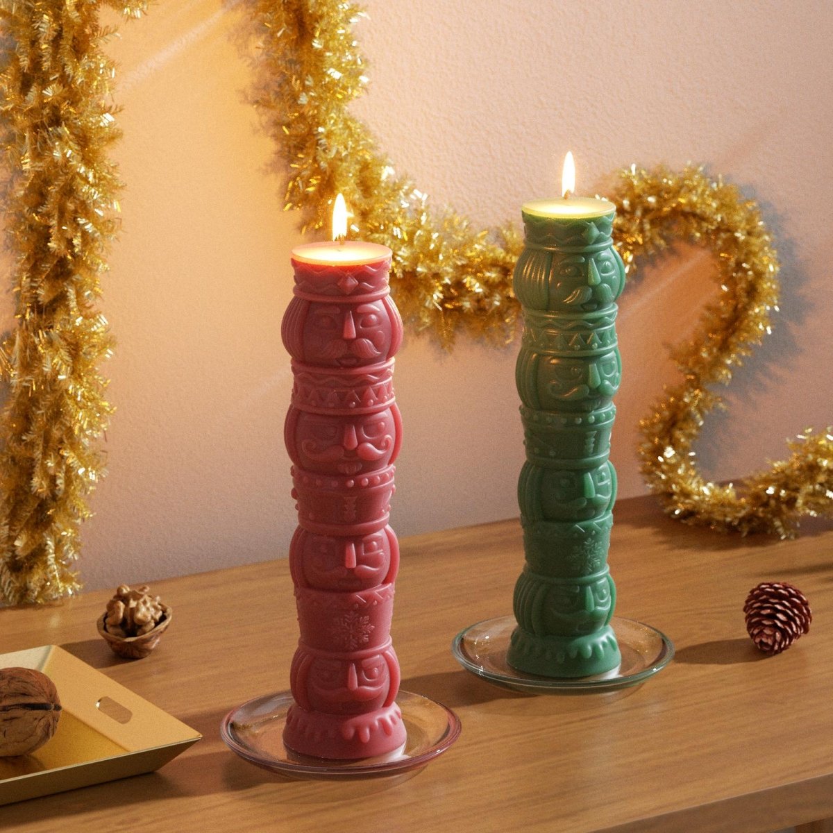 Red and green nutcracker totem pillar candles burning on a holiday table – festive 3D Christmas decor with gold garland - Boowan Nicole