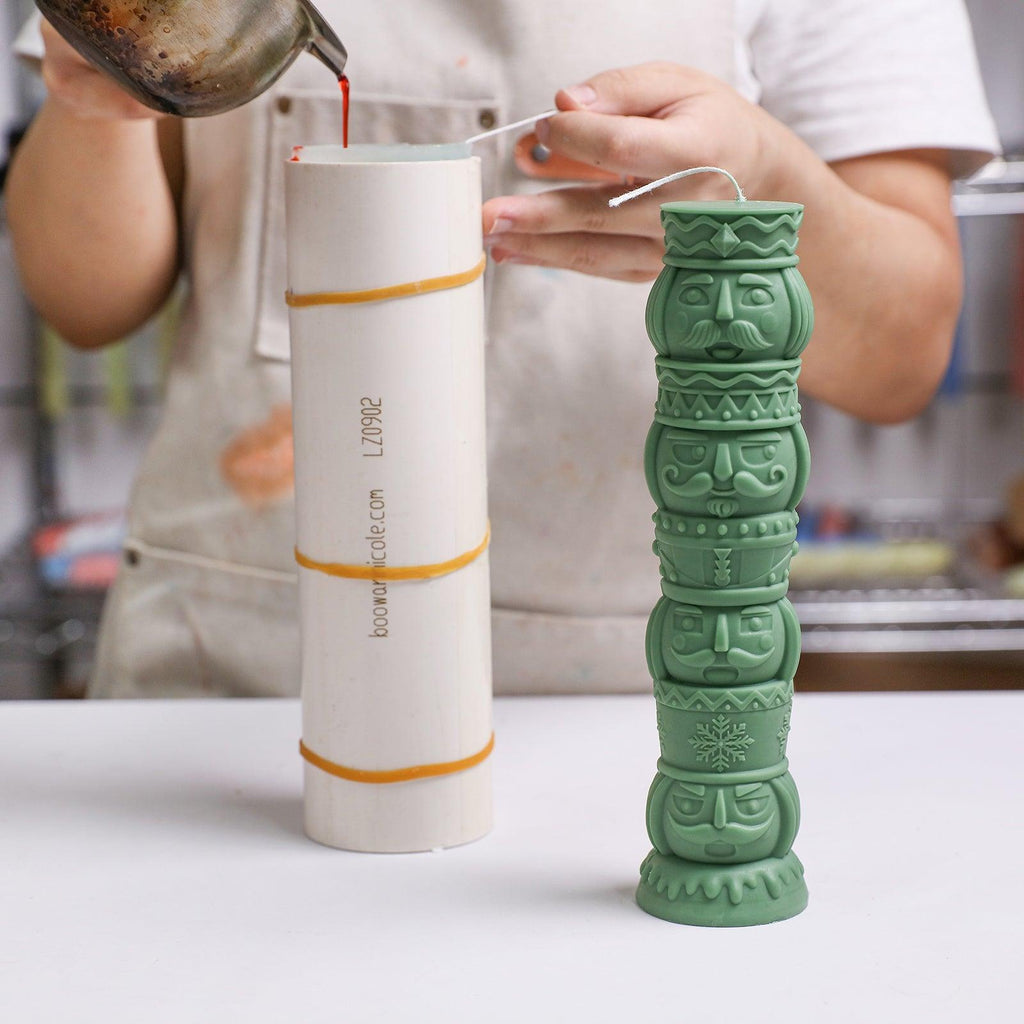 Pouring prepared wax into a nutcracker candle silicone mold with support shell - Boowan Nicole