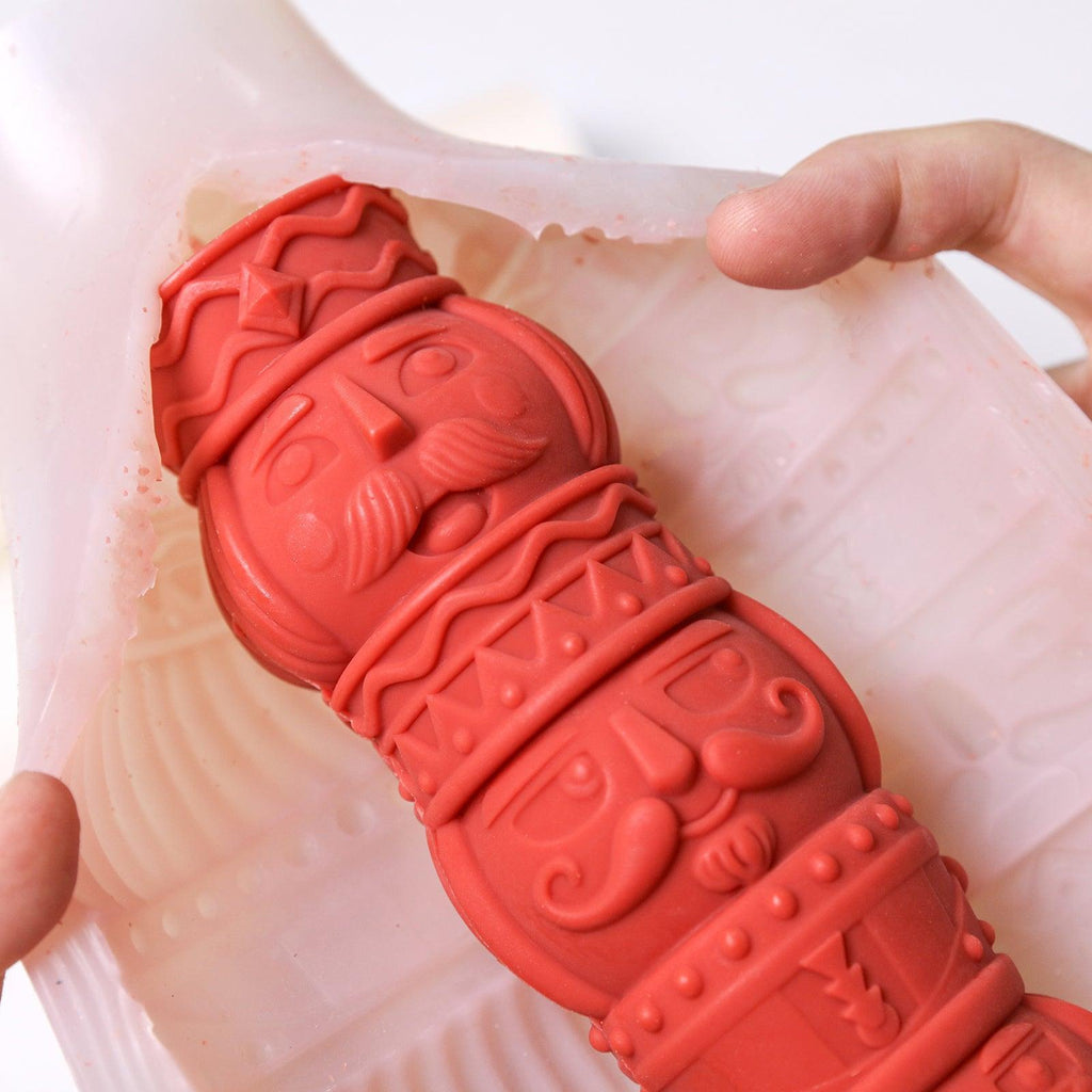 Demolding a red nutcracker totem candle from flexible silicone mold – revealing detailed 3D carving - Boowan Nicole