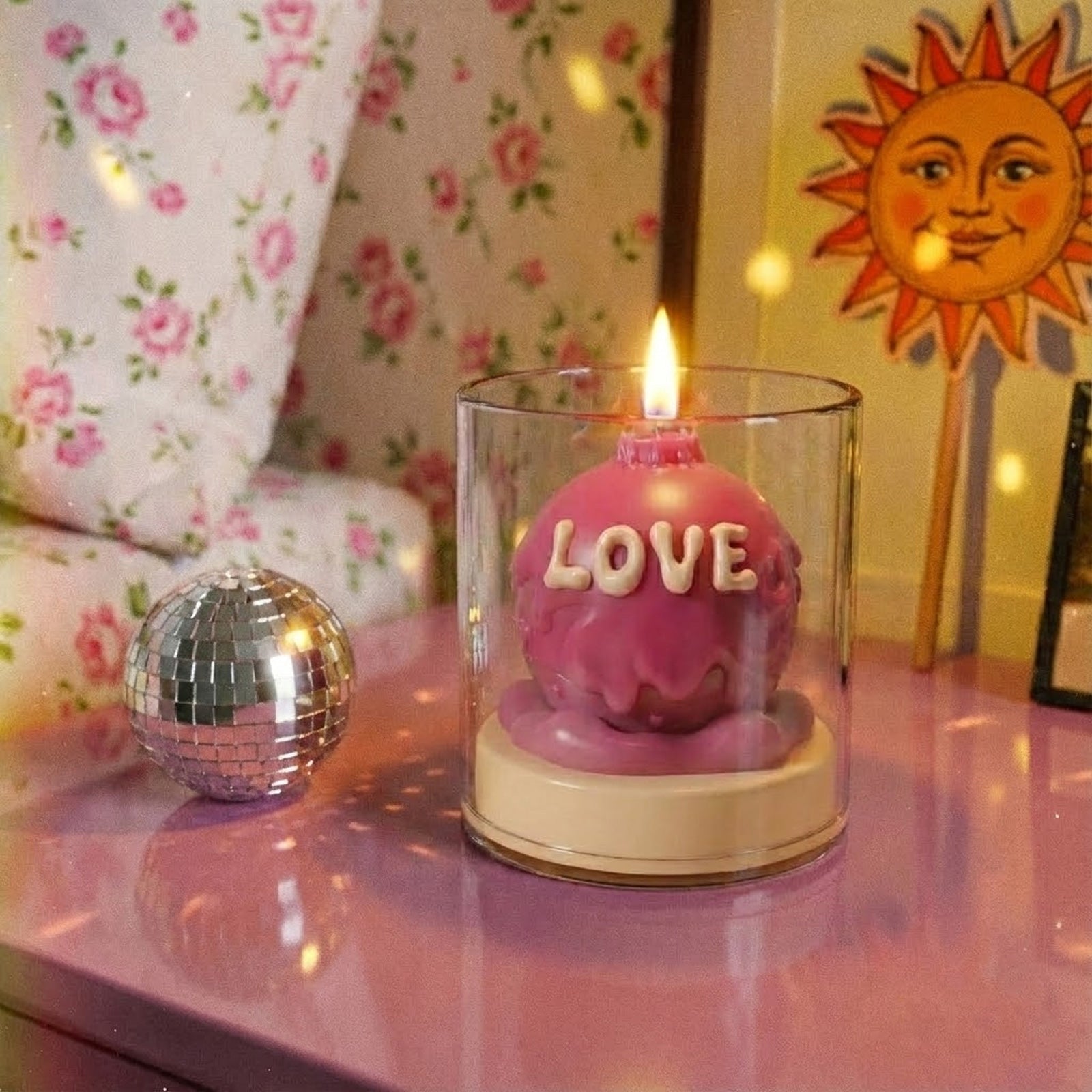 Lit pink "LOVE" dripping wax candle in a glass jar, aesthetic Y2K bedroom decor with a disco ball - Boowan Nicole