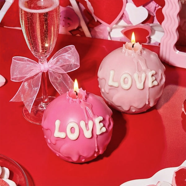 Lit pink LOVE candles with dripping wax in a romantic Valentine's Day date night setting - Boowan Nicole