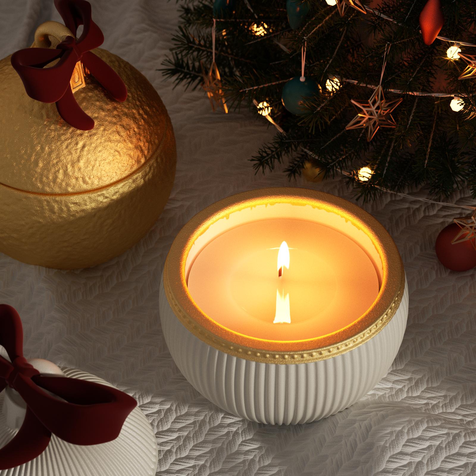 Lit Christmas bauble candle jar with gold rim and red ribbon bow beside Christmas tree - Boowan Nicole