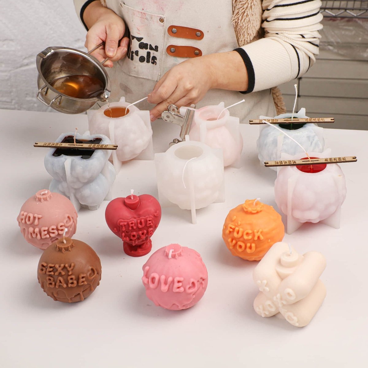 Pouring liquid wax into Large Boomy Love 3D sassy quote candle molds - Boowan Nicole
