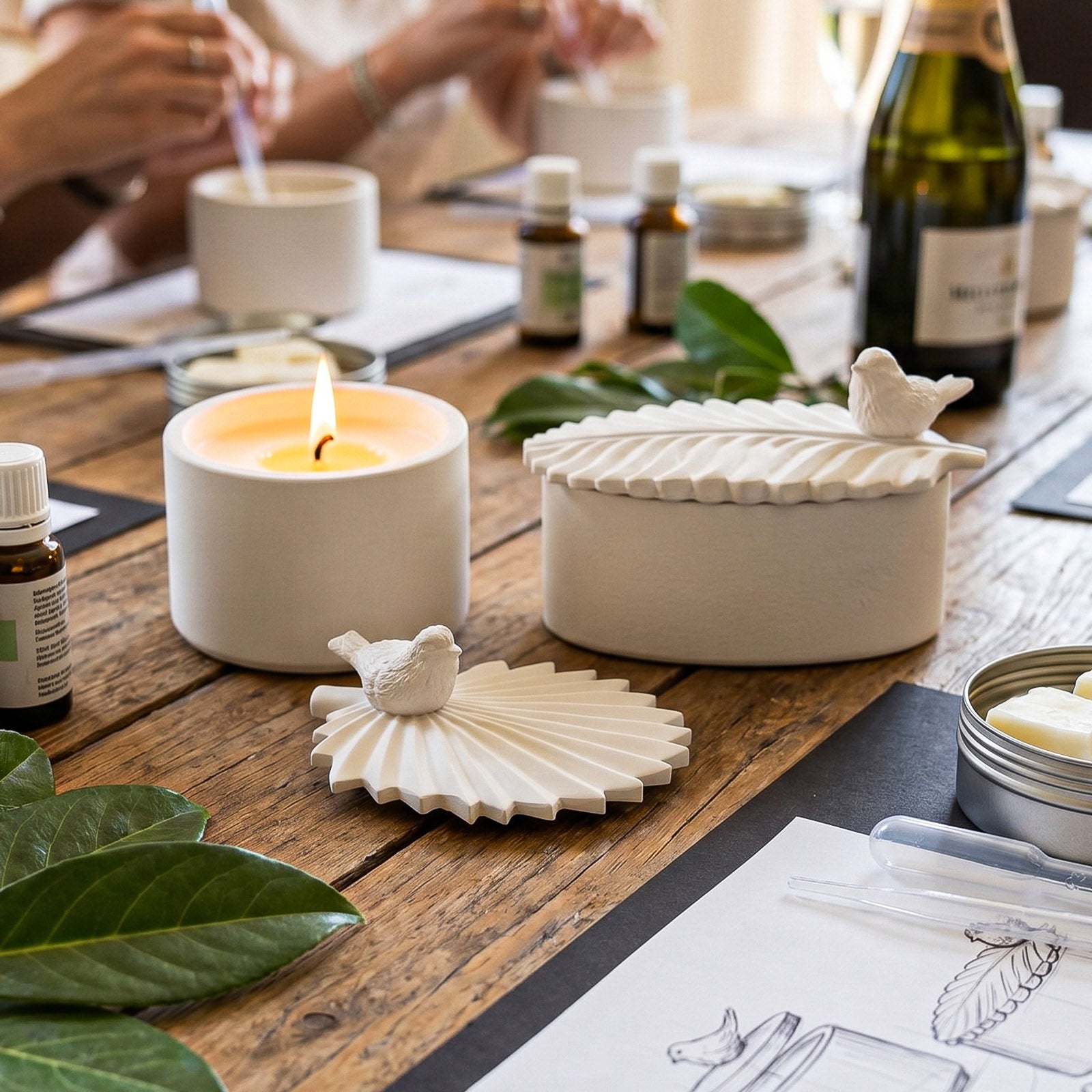 Bird & Leaf Candle Jars and lids in workshop setting - Boowan Nicole