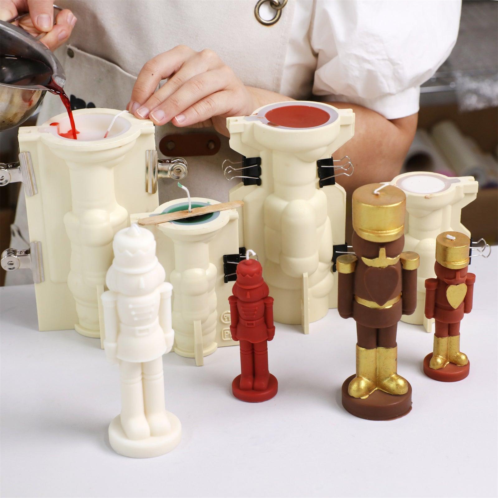 Pouring wax into nutcracker silicone molds with support shells—showing finished candles in various stages of decoration - Boowan Nicole