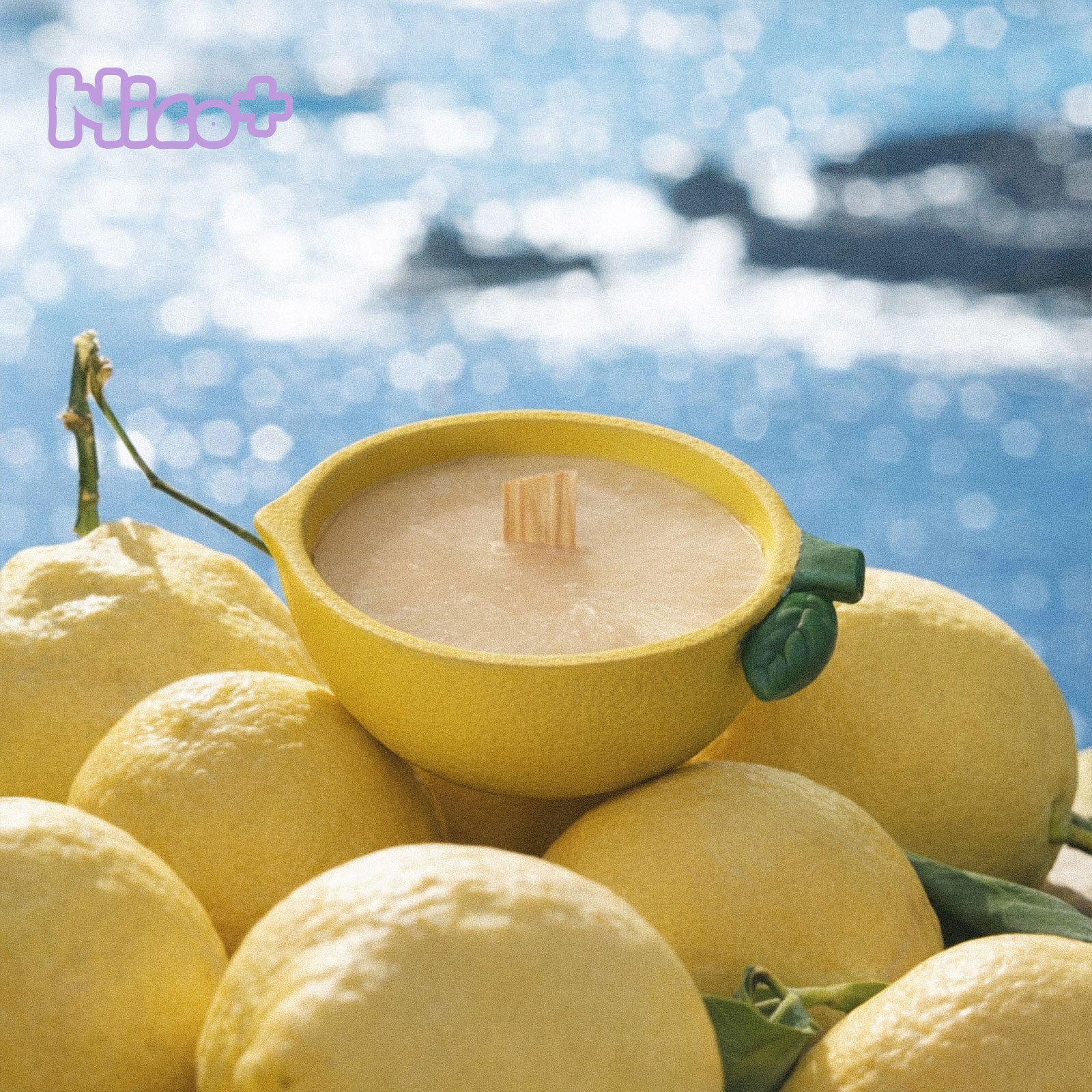 Lemon Shaped Bowl Candle Rested Among Fresh Lemons by Sparkling Water - Boowan Nicole