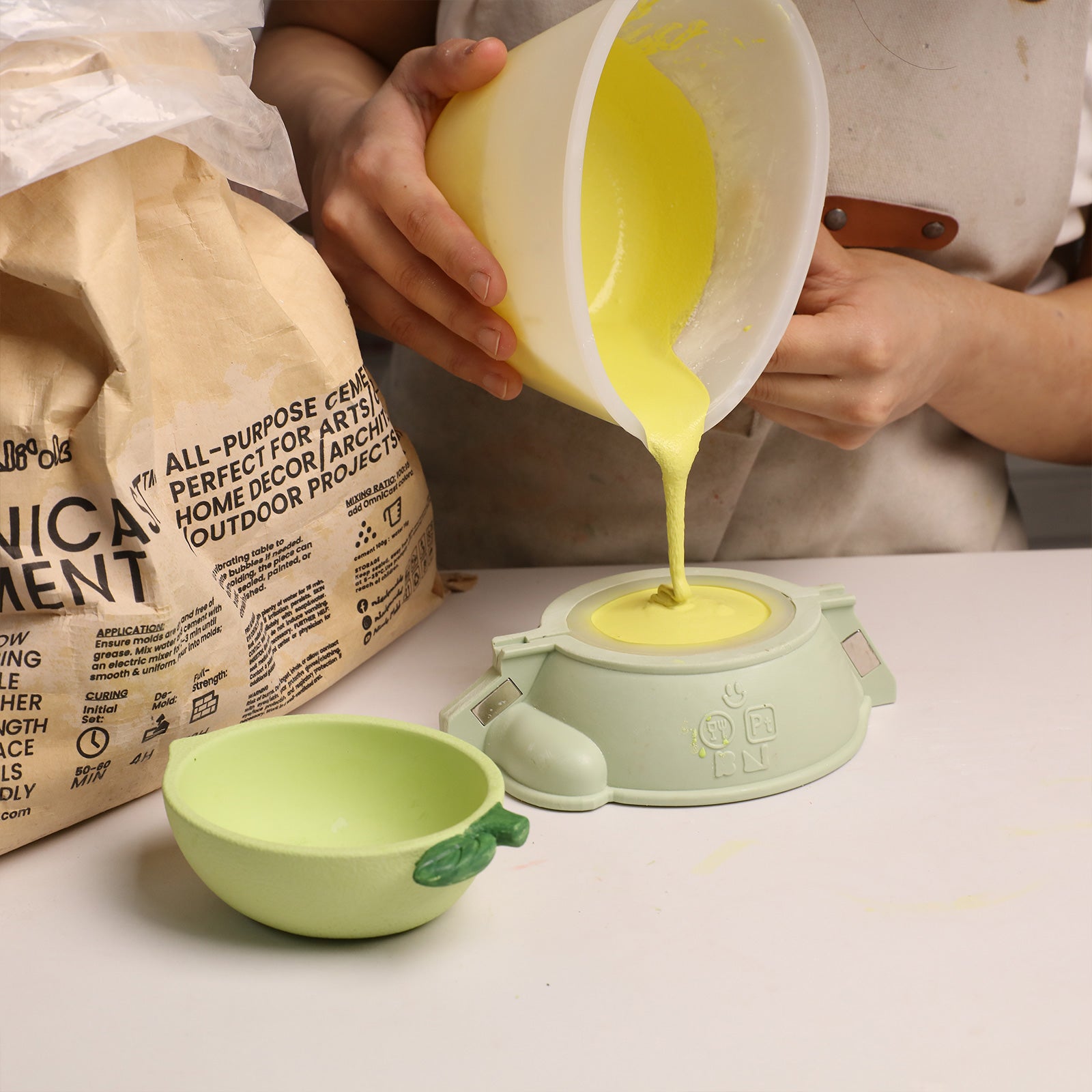 Pouring Yellow Craft Mixture into Lemon Boat Silicone Candle Mold - Boowan Nicole