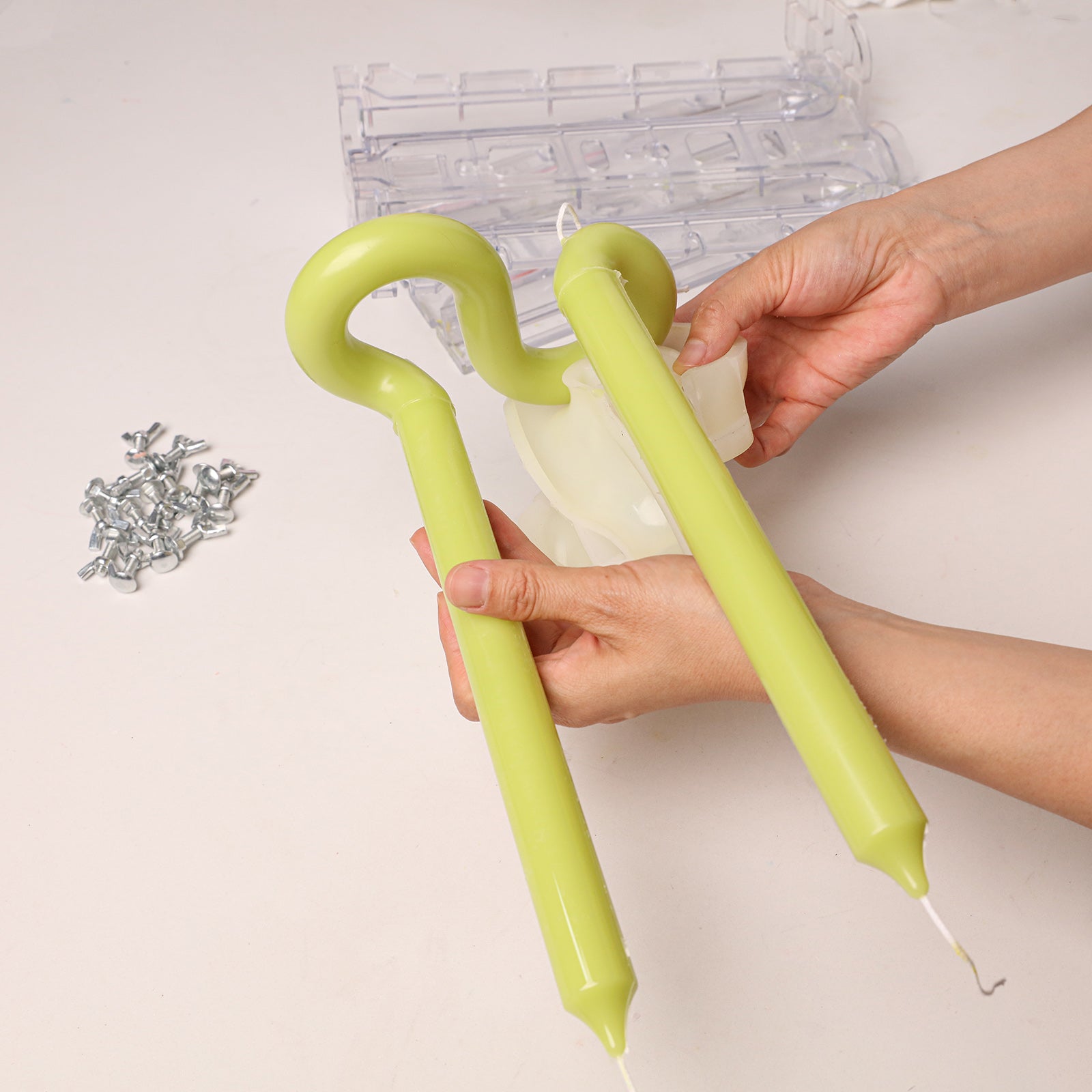 Looped Taper Acrylic Candle Mold, unmolding finished green looped taper candles from clear mold - Boowan Nicole