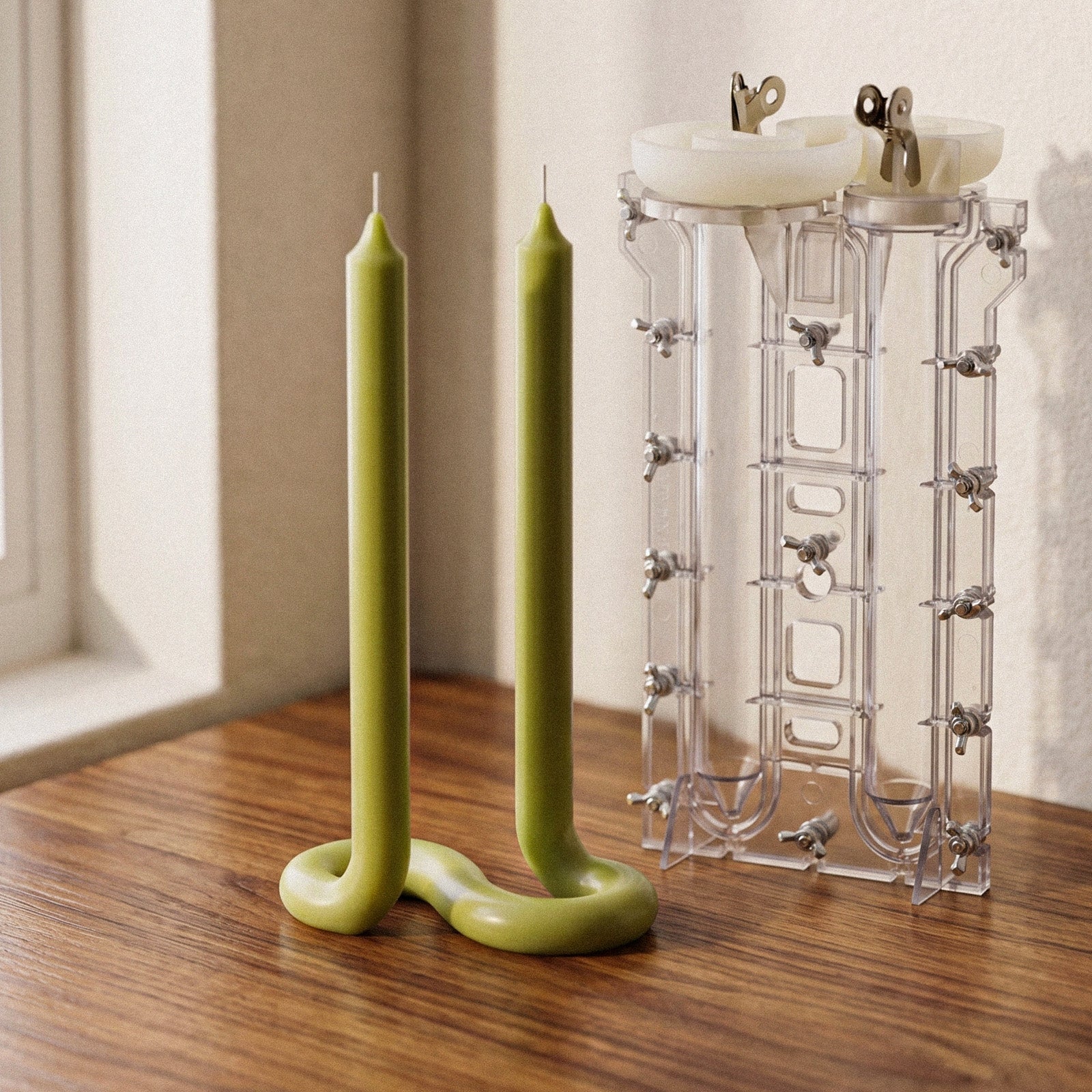 Looped Taper Acrylic Candle Mold, clear molds next to finished green looped taper candles on wooden table - Boowan Nicole